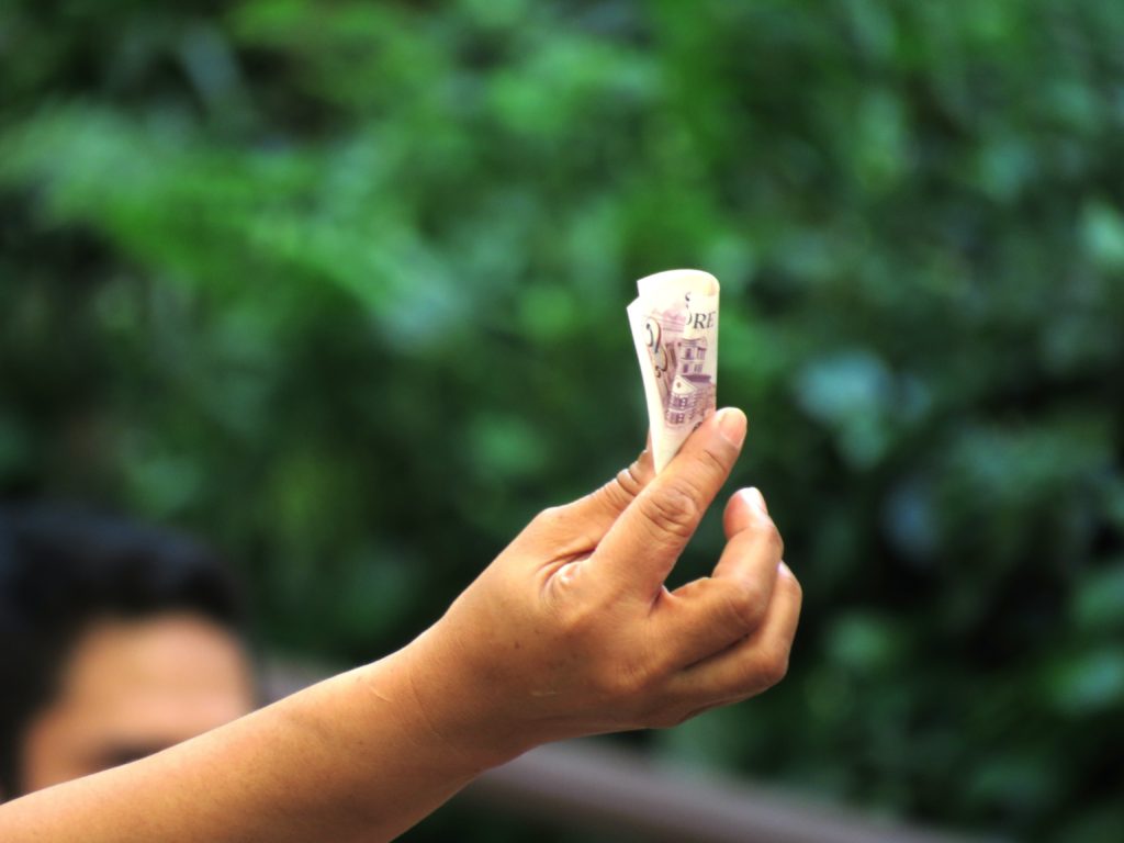 Hand holding Singaporean dollars