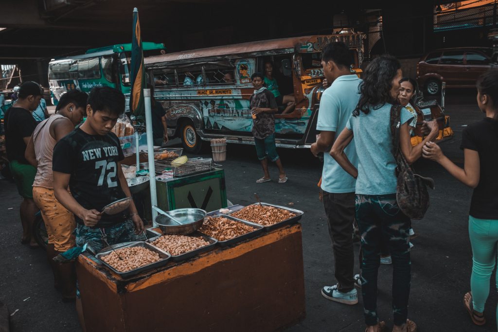 Philippine street with food vendors and jeepneys