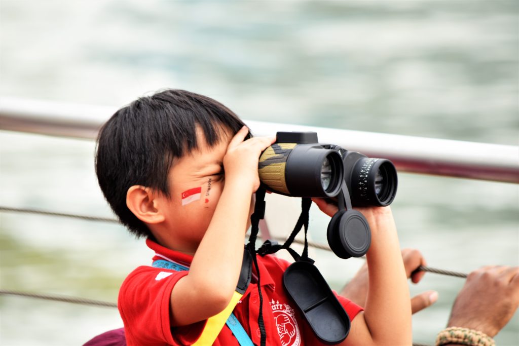 Singaporean boy with binoculars